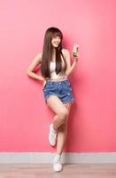 Young Asian woman on pink background photo