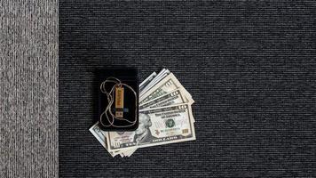 USB disk with private data and money on a two-tone textile background. photo