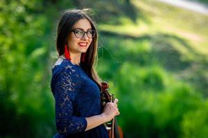 Young woman  with violin at park. Shallow depth of field - image photo