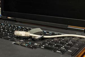 Lock and network cable on a notebook computer photo