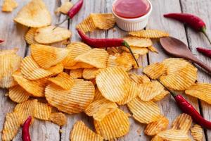 Homemade paprika potato chips and Chili sauce photo