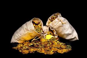 Stack gold coin in treasure sack photo