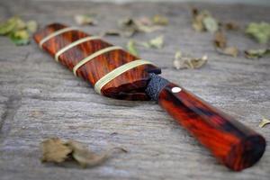 knife custom or Enep in the natural wood scabbard on old table background handmade of Thailand photo