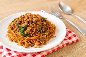 Stir-fried instant noodles with Thai basil and minced pork - Asian food style photo