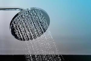 Close up of Water flowing from shower in the bathroom photo