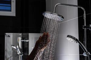 Close up of Water flowing from shower in the bathroom photo