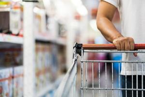 Close-up of Man pushing shopping cart in a supermarket