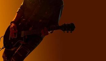 Musician guitarist player, Silhouette of guitar player on the stage photo