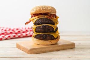 Hamburger or beef burgers with cheese, bacon, and french fries - unhealthy food style