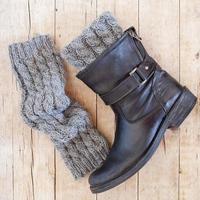 Black leather boot and grey knitted wood legwarmers photo