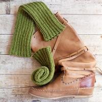 Brown leather high boot and knitted green wood legwarmers photo