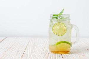 Iced honey and lime soda with mint - refreshing drink photo