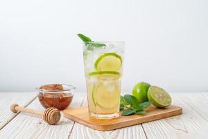 Iced honey and lime soda with mint - refreshing drink photo