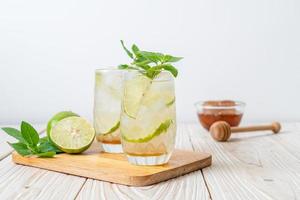 Iced honey and lime soda with mint - refreshing drink photo