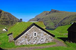 El histórico pueblo de Saksun en las Islas Feroe en un gran día con cielo azul en verano foto