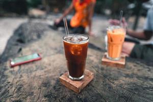 Iced coffee in a glass on a wooden table photo