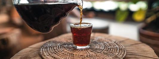 Pouring a hot water over a drip coffee photo