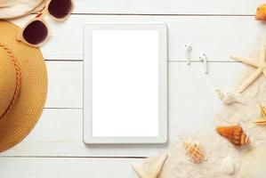 Summer background with blank screen phone and beach accessories on white wooden background top view with copy space. photo