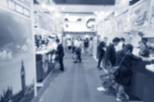 Abstract blurred people in exhibition, expo in hall photo