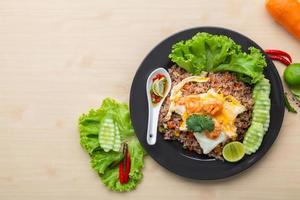 Fried rice with shrimp in black dish on the table photo