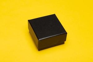 Black box packaging on yellow background photo