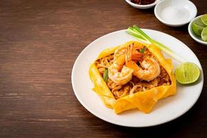 Thai stir fried noodles with shrimps and egg wrap or Pad Thai photo