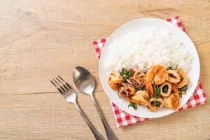 Rice and stir-fried seafood of shrimp and squid with Thai basil - Asian food style