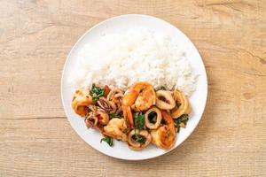 Rice and stir-fried seafood of shrimp and squid with Thai basil - Asian food style