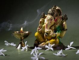 Hindu God Ganesha. Ganesha Idol. A colorful statue of Ganesha Idol on dark background. space for text or headline. photo