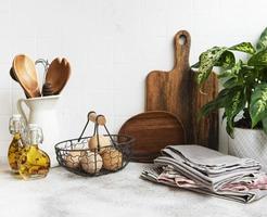 Kitchen utensils, tools and dishware on on the background white tile wall. photo