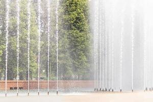 Background of the jets and splashes of the fountain in the park photo