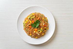 Fried rice with green peas, carrots, and corn - vegetarian and healthy food style photo