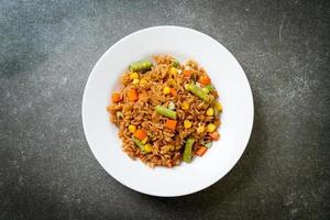 Fried rice with green peas, carrots, and corn - vegetarian and healthy food style photo