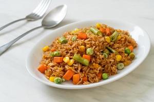 Fried rice with green peas, carrots, and corn - vegetarian and healthy food style photo