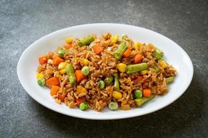 Fried rice with green peas, carrots, and corn - vegetarian and healthy food style photo