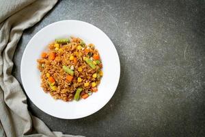 Fried rice with green peas, carrots, and corn - vegetarian and healthy food style photo