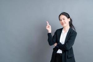Asian woman with hand presenting on side photo