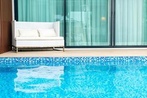 Empty outdoor patio chair near swimming pool photo