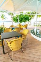 Empty outdoor patio chair near swimming pool photo