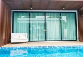 Empty outdoor patio chair near swimming pool photo