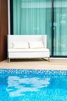 Empty outdoor patio chair near swimming pool photo