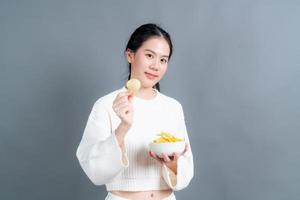 Young Asian woman eat potato chips photo