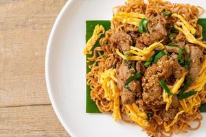 Stir-fried instant noodle with pork and egg - Asian local street food style photo