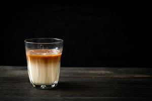 Glass of latte coffee, coffee with milk on wood background photo