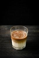 Glass of latte coffee, coffee with milk on wood background photo