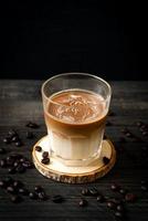Glass of latte coffee, coffee with milk on wood background photo