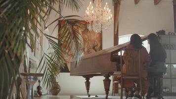 Hands of girl and woman touching keys of piano video