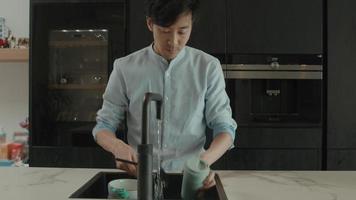 Man cleans mug at sink video