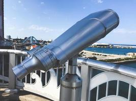 Observation binoculars on the bridge and Sokcho city on the background, South Korea photo