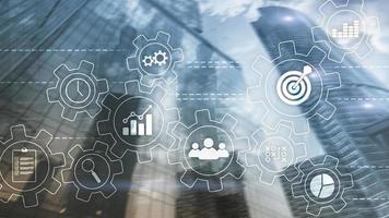 Business process automation concept. Gears and icons on abstract background photo